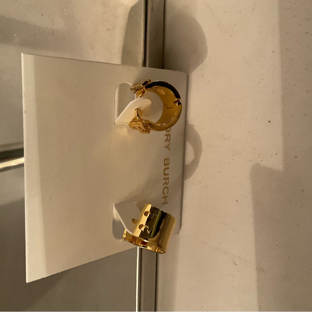 Tory Burch gold tone earrings marked with the “T”